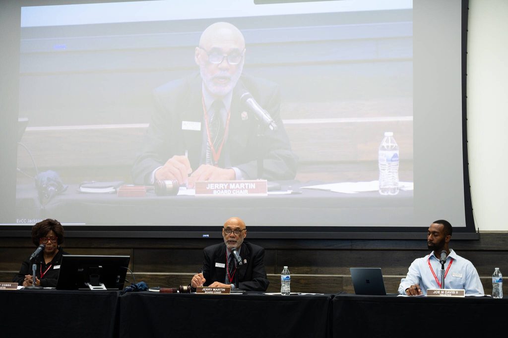 Will Geschke / The Herald
Jerry Martin, center, chair of the Everett Community College Board of Trustees, reads a statement on the colleges decision to close its Early Learning Center during a board meeting on Tuesday in Everett.