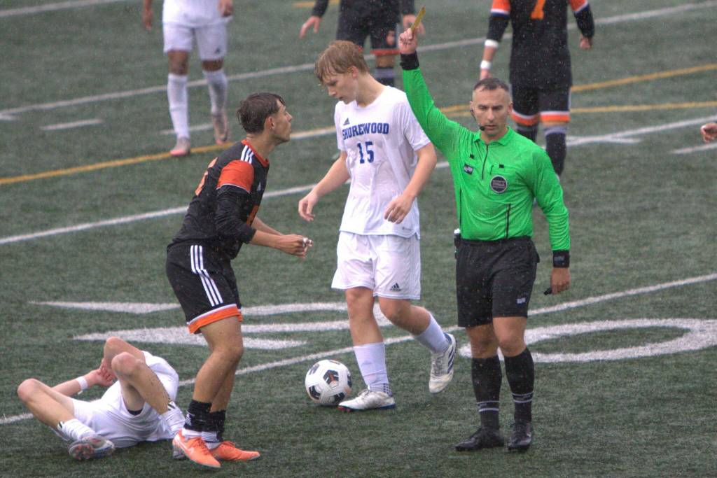 Monroes Cody Duncan is assessed a yellow card at the end of the first half during the District 1 3A boys soccer championship game against Shorewood on May 17, 2025 at Shoreline Stadium. (Qasim Ali / The Herald)
