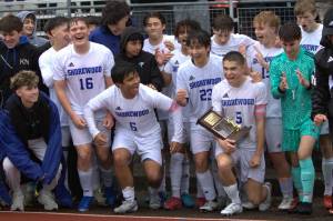 The Shorewood boys soccer team celebrates with their trophy after winning the District 1 3A title on May 17, 2025 at Shoreline Stadium. (Qasim Ali / The Herald)