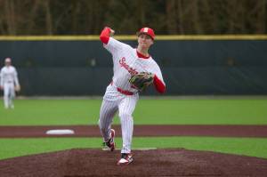 File Photo: Stanwood senior Gavin Gehrman delivers a pitch during the Spartans' 8-3 win against Arlington in Stanwood, Washington on March 19, 2025. In Stanwood's 7-4 loss to Mount Vernon in the District 1 3A Championship on May 17, 2025, Gehrman went 2-for-4 with 2 RBI. (Joe Pohoryles / The Herald)