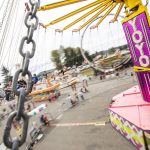 People laugh as they ride the Yoyo swings at the carnival during the opening day of the Evergreen State Fair on Thursday, Aug. 22, 2024 in Monroe, Washington. (Olivia Vanni / The Herald)