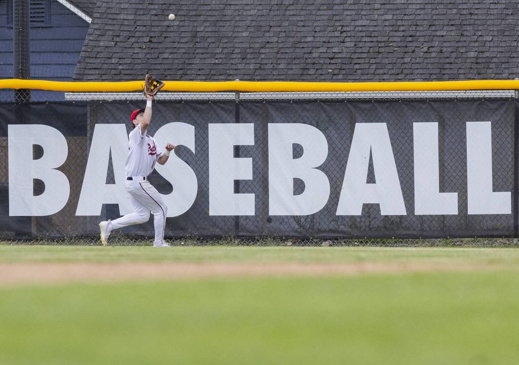 A Snohomish player makes a catch in the outfield during the opening round 3A state game against Bellevue on Tuesday, May 20, 2025 in Snohomish, Washington. (Olivia Vanni / The Herald)