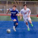 Shorewood junior Tally Lord dribbles the ball upfield past Central Kitsap senior Keegan Bailey during the Stormrays 1-0 win in the 3A Boys Soccer State Round of 16 in Shoreline, Washington on May 22, 2025. (Joe Pohoryles / The Herald)