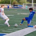 Shorewood senior Matthew Bereket (right) lunges in to challenge a kick from Central Kitsap freshman Eli Daniels during the Stormrays 1-0 win in the 3A Boys Soccer State Round of 16 in Shoreline, Washington on May 22, 2025. (Joe Pohoryles / The Herald)