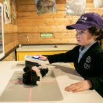 Aaron Weinstock uses an x-ray machine toy inside the Imagine Children Museum on Tuesday, Dec. 3, 2024 in Everett, Washington. (Olivia Vanni / The Herald)