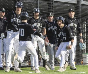 Jackson players celebrate teammate MJ Holcomb scoring during the game against Edmonds-Woodway on Wednesday, April 2, 2025 in Edmonds, Washington. (Olivia Vanni / The Herald)