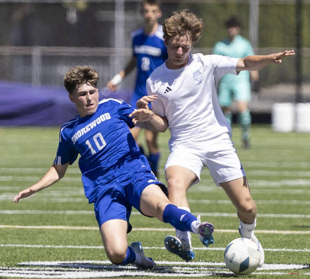 Shorewoods Niki Genadiev slides to knock the ball away during the 3A state semifinal game against Ingraham on Friday, May 30, 2025 in Puyallup, Washington. (Olivia Vanni / The Herald)