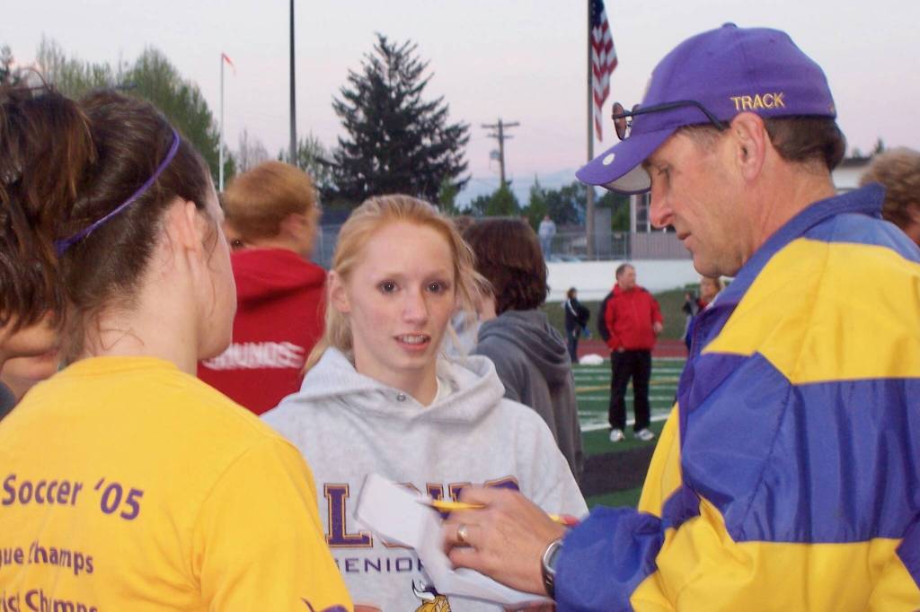 Jeff Page (right) advises his daughter, Elise (center), during a Lake Stevens track meet on May 12, 2006. (Photo courtesy of Jeff Page)