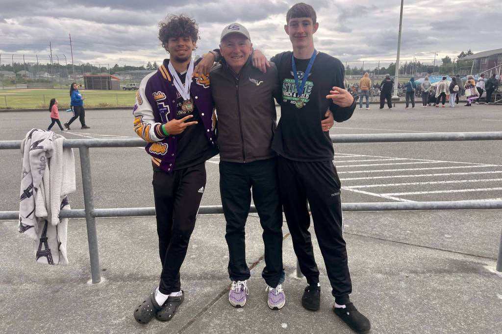 Steven Lee Jr. (left) and David Boogy Brown (right) pose with Jeff Page after the 2024 4A State Championships at Mount Tahoma High School. (Photo courtesy of Jeff Page)