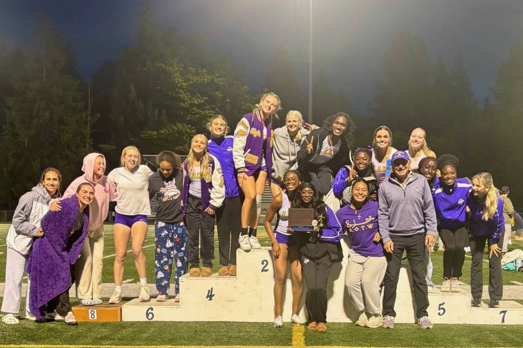 Jeff Page stands by the podium with the Lake Stevens girls track & field team after they won the Wesco 4A Championship on May 16, 2025. (Photo courtesy of Jeff Page)