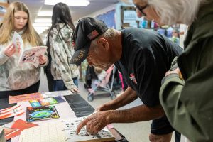Brian Murril, who started at Liberty Elementary as a kindergartner in 1963, looks for his yearbook photograph during an open house for the public to walk through the school before its closing on Thursday, May 29, 2025 in Marysville, Washington. (Olivia Vanni / The Herald)