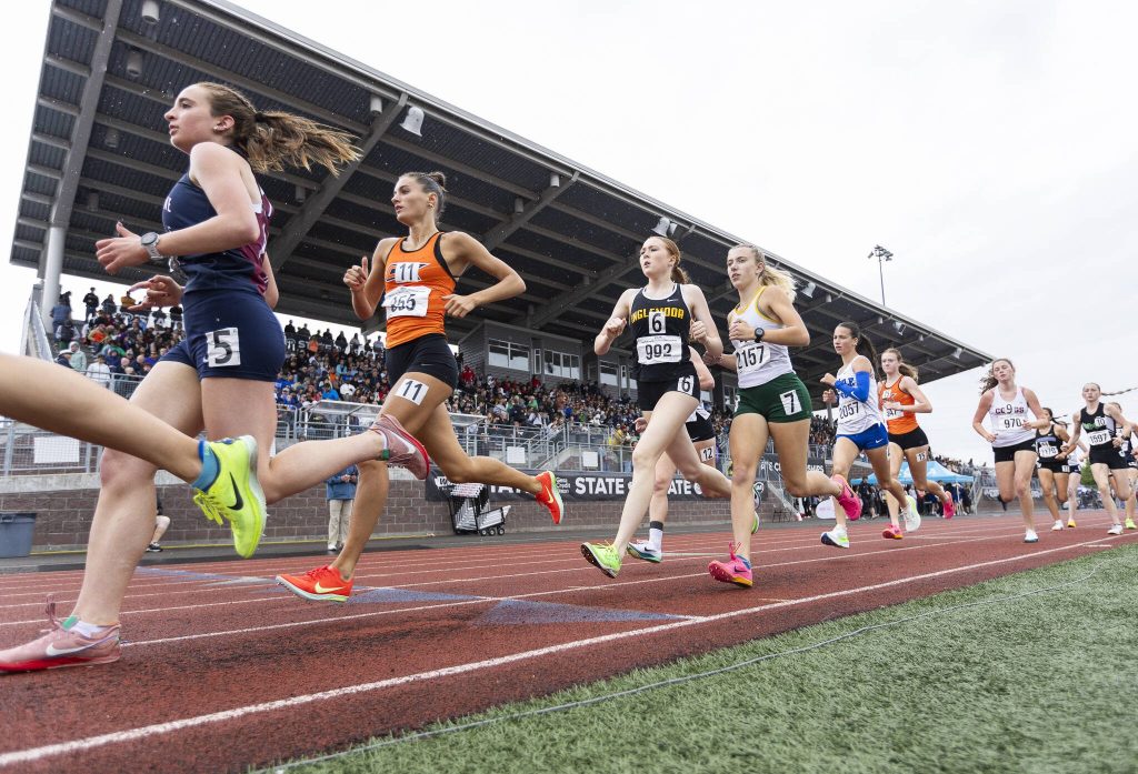 Runners pass by the stands at Mt. Tahoma high school in the 3A girls 3200 meter final on Saturday, May 31, 2025 in Tacoma, Washington. (Olivia Vanni / The Herald)