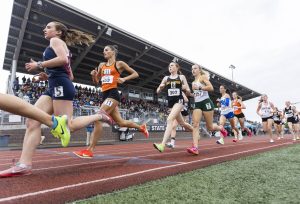 Runners pass by the stands at Mt. Tahoma high school in the 3A girls 3200 meter final on Saturday, May 31, 2025 in Tacoma, Washington. (Olivia Vanni / The Herald)