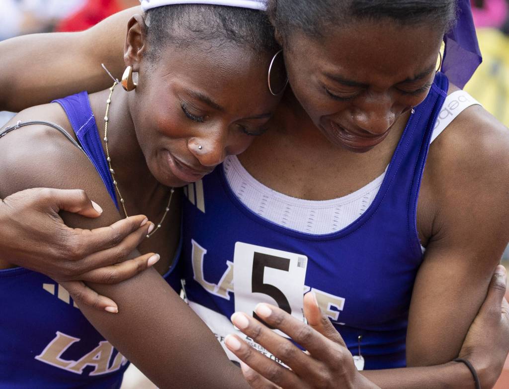 Lake Stevens Haddyjatou Ceesay, left, embraces Brianna Tilgham as she cries after coming in second in the 4A girls 4x100 relay final on Saturday, May 31, 2025 in Tacoma, Washington. (Olivia Vanni / The Herald)