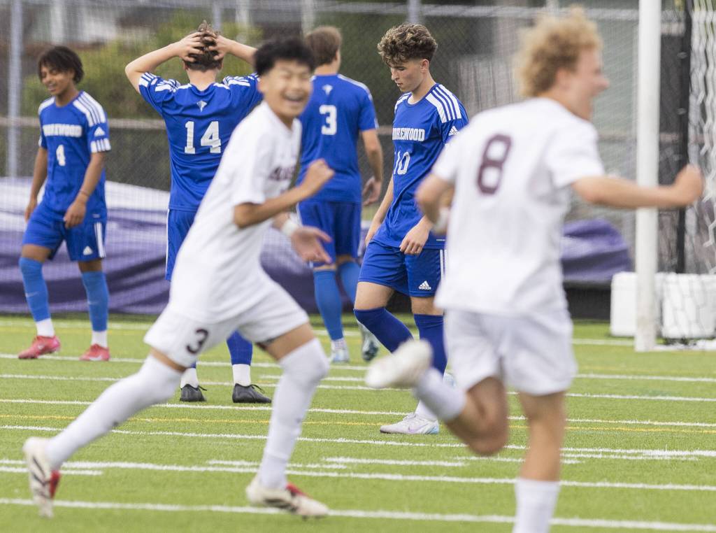 Shorewoods Niki Genadiev looks down as Mercer Island players run past celebrating a goal during the 3A state championship game on Saturday, May 31, 2025 in Puyallup, Washington. (Olivia Vanni / The Herald)