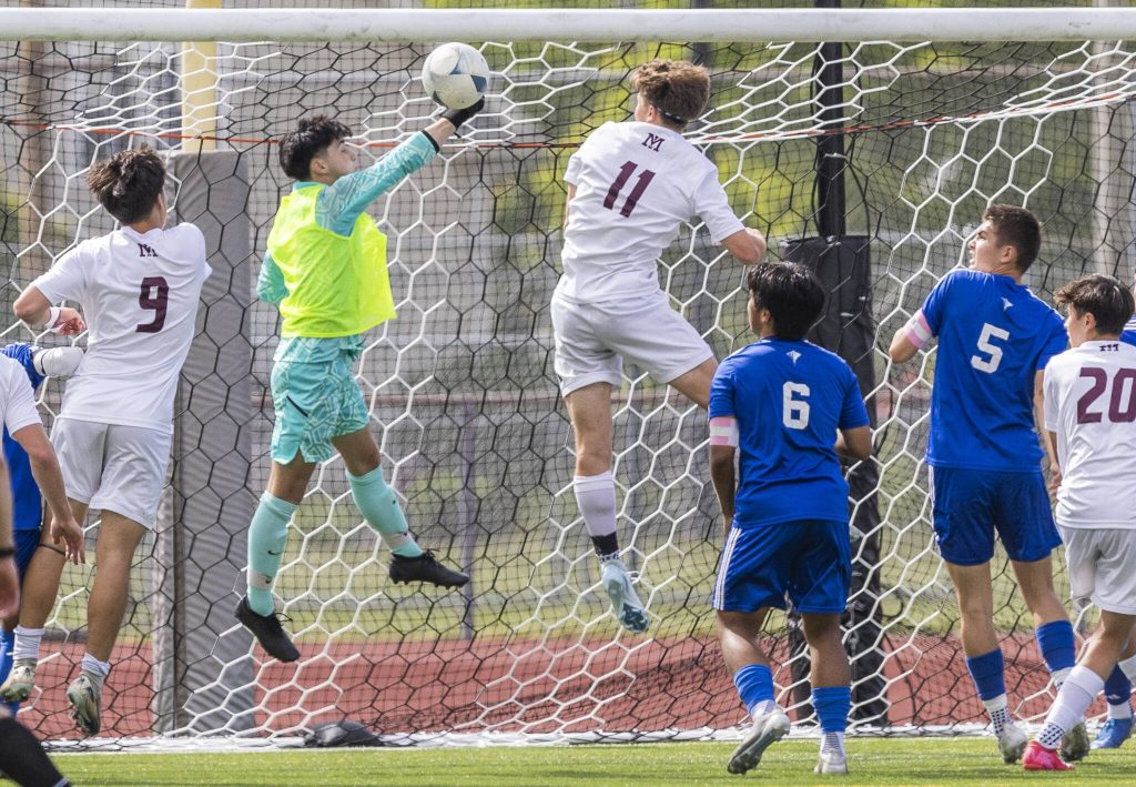 Shorewoods Ivan Genadiev punches the ball over the top of the goal post during the 3A state championship game against Mercer Island on Saturday, May 31, 2025 in Puyallup, Washington. (Olivia Vanni / The Herald)