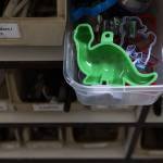 A green dinosaur cookie cutter sticks out of a drawer at the Good Cheer Thrift Store in Langley. (Olivia Vanni / The Herald)