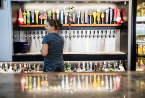 Bar manager Faith Britton pours a beer for a customer at the Madison Avenue Pub in Everett. (Olivia Vanni / The Herald)