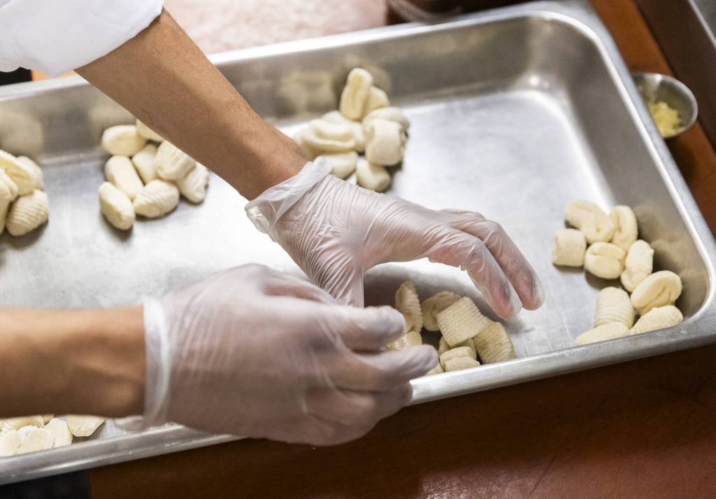 Jahmarion Morey separates gnocchi into individual servings at the Edmonds College Cafe on Thursday, May 29, 2025 in Lynnwood, Washington. (Olivia Vanni / The Herald)