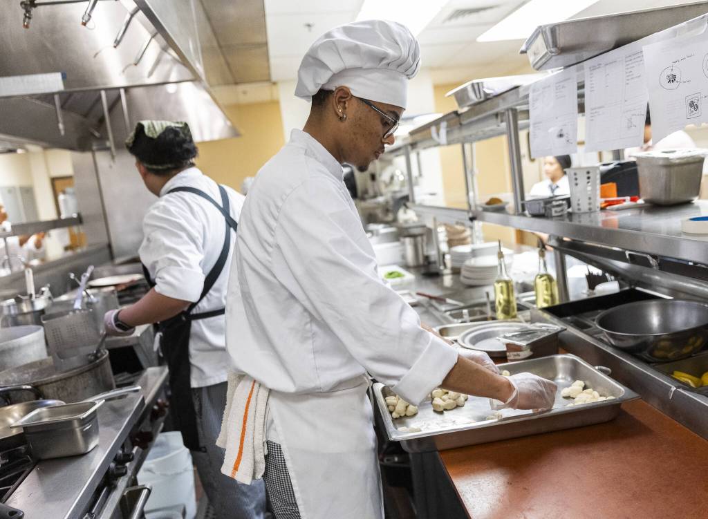 Jahmarion Morey separates gnocchi into individual servings before cooking at the Edmonds College Cafe on Thursday, May 29, 2025 in Lynnwood, Washington. (Olivia Vanni / The Herald)