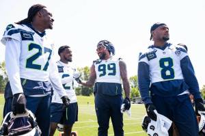 Seahawks cornerback Riq Woolen (27), cornerback Devon Witherspoon (21), defensive end Leonard Williams (99) and safety Coby Bryant (8) convene during Seahawks OTAs on Monday June 2, 2025 at the Virginia Mason Athletic Center. (Photo courtesy of Rod Mar / Seattle Seahawks)