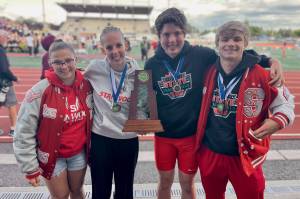 Stanwood's mixed unified 400-meter relay team -- (from left to right) senior Ciara Beam, sophomore Camrie Ingram, junior Xander Krause and junior Levi Stiers -- poses with their medals and state championship trophy at the WIAA Track & Field Championships in Tacoma, Washington on May 31, 2025. (Photo courtesy of Michael Randall / Stanwood track & field)