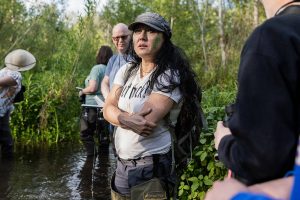 Cascadia College Earth and Environmental Sciences Professor Midori Sakura looks in the surrounding trees for wildlife at the North Creek Wetlands on Wednesday, June 4, 2025 in Bothell, Washington. (Olivia Vanni / The Herald)