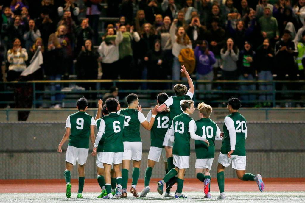 The Edmonds-Woodway boys soccer team, including sophomore midfielder Alex Plumis (13), celebrates a 4-3 win over Everett on May 1, 2023 at Edmonds-Woodway High School. (Courtesy of Edmonds-Woodway boys soccer / Michael Bury / Photobury)