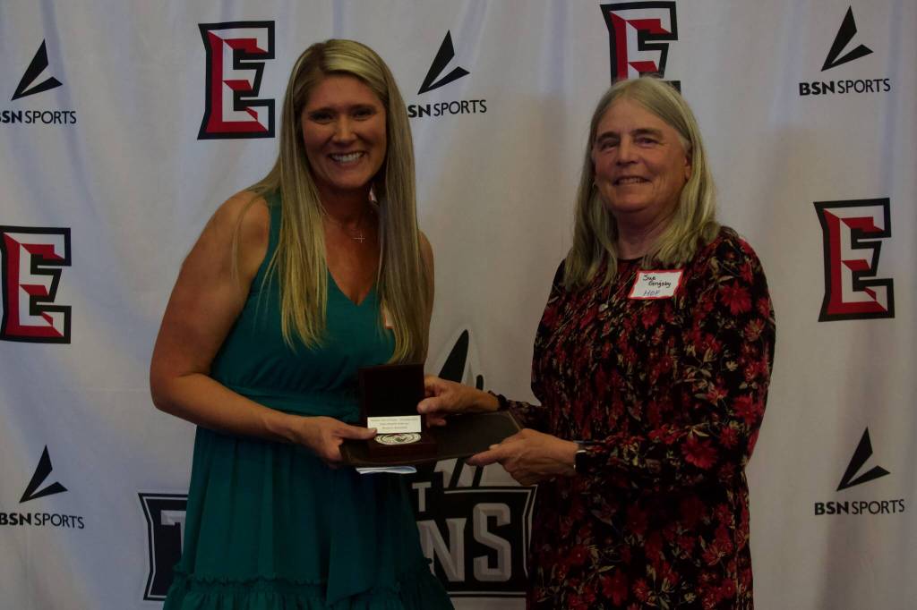 EvCC Hall of Famer Sue Grigsby presents Nikki Anderson with her award at the Everett Community College Athletics 2025 Hall of Fame Induction Ceremony in Everett, Washington on June 5, 2025. Anderson starred on the 2002-03 womens basketball team under coach Chet Hovde. (Joe Pohoryles / The Herald)