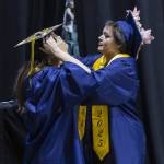 Gabriella Hurley, right, helps secure Anya Kozinas graduation cap before the start of Mariner High Schools 2025 commencement on Friday, June 13, 2025, at Angel of the Winds Arena in Everett, Washington. (Olivia Vanni / The Herald)