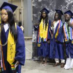 Jalika Kunjo, left, Ral Kanu, center, and Kaddijatou Jawara, right, takes photos before the start of Mariner High Schools 2025 commencement on Friday, June 13, 2025, at Angel of the Winds Arena in Everett, Washington. (Olivia Vanni / The Herald)