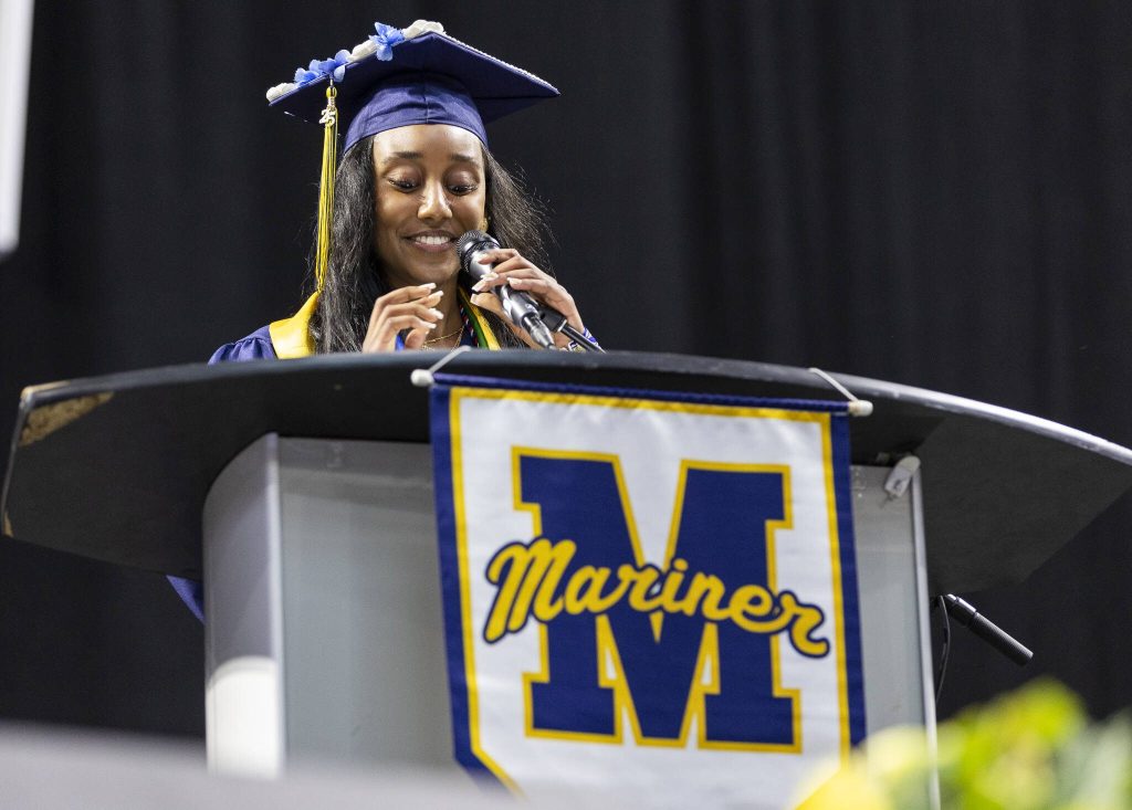 Senior class president Delina Belay smiles while speaking during Mariner High Schools 2025 commencement on Friday, June 13, 2025, at Angel of the Winds Arena in Everett, Washington. (Olivia Vanni / The Herald)