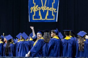 Julia Zavgorodniy waves at her family after scanning the crowd to find them during Mariner High School’s 2025 commencement on Friday, June 13, 2025, at Angel of the Winds Arena in Everett, Washington. (Olivia Vanni / The Herald)