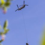 A helicopter moves a tree to a engineered log jam along the Pilchuch River on Wednesday, June 11, 2025 in Granite Falls, Washington. (Olivia Vanni / The Herald)