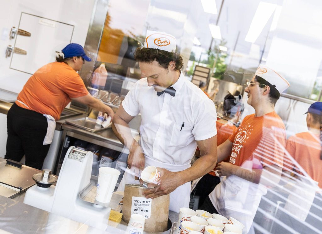 Dicks Drive-In employee Cole Roberts scoops ice cream for milkshakes in preparation of the grand opening on Thursday, June 12, 2025 in Everett, Washington. (Olivia Vanni / The Herald)