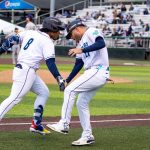 Everett AquaSox infielder Michael Arroyo (left) slaps bench coach Hecmart Nieves' hand while rounding third base after hitting a home run during Everett's 8-1 win against Tri-City at Funko Field in Everett, Washington on June 13, 2025. (Shari Sommerfeld / Everett AquaSox)