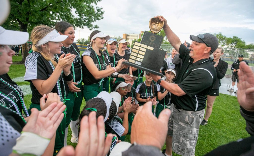 Jackson High Schools Kyle Peacocke hands the 2023 WIAA Class 4A softball championship trophy to the team after their win in Richland on May 27, 2023. (TJ Mullinax / for The Herald)