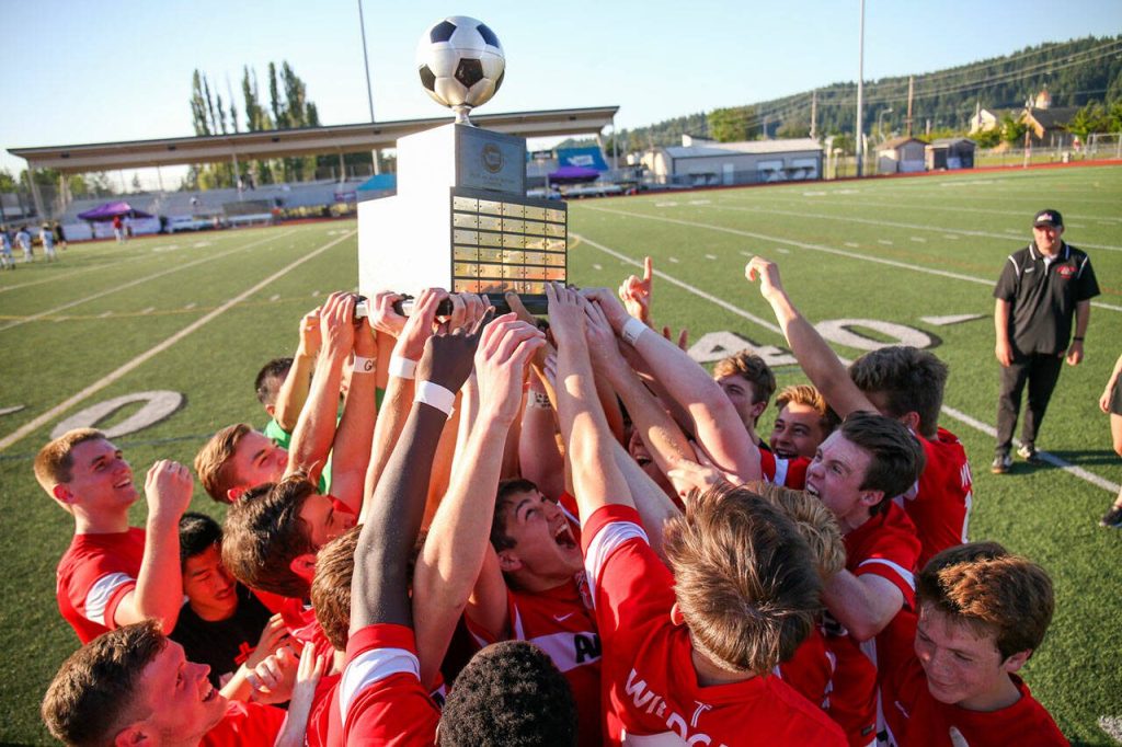 Archbishop Murphy celebrates their win for the 2A state soccer championship in Sumner on May 27, 2017 as coach Mike Bartley looks on. (Kevin Clark / The Herald)