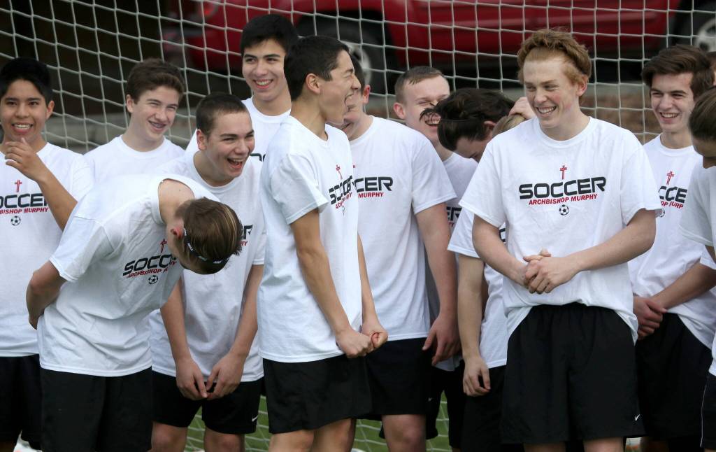 Archbishop Murphy soccer players laugh while trying to make a team video before the start of practice on Tuesday, Mar. 15, 2016 in Washington (Andy Bronson / The Herald)