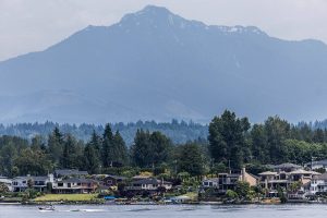 A boat drives along Lake Stevens with Mount Pilchuck visible in the background on Tuesday, June 24, 2025 in Lake Stevens, Washington. (Olivia Vanni / The Herald)