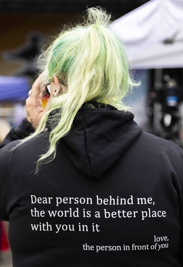 Rene Biggerstaff wears a sweatshirt with the phrase, Dear person behind me, the world is a better place with you in it, during the Everett Pride Block Party on Saturday, June 21, 2025 in Everett, Washington. (Olivia Vanni / The Herald)