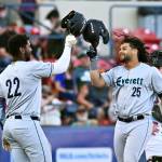 AquaSox designated hitter Freuddy Batista (25) celebrates with right fielder Lazaro Montes (22) during a 9-3 victory over the Spokane Indians on Wednesday, June 18th at Avista Stadium in Spokane. (Photo courtesy of James Snook)