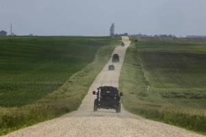 Minnesota State Patrol Special Response Team vehicles on a rural road during a manhunt for a man suspected of assassinating a Democratic state lawmaker and attempting to kill another, in Green Isle, Minn., on Sunday, June 15, 2025. A man suspected of assassinating a Minnesota lawmaker on Saturday and of shooting another was identified by the authorities as Vance Boelter, 57. (Tim Gruber/The New York Times)