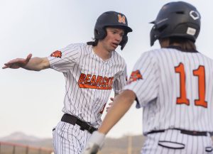 Monroe’s Caleb Campbell high-fives his teammate Mike Enrico after scoring during the game against Everett on Wednesday, April 23, 2025 in Monroe, Washington. (Olivia Vanni / The Herald)