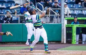 Michael Arroyo hits a 2-run home run for the Everett AquaSox as Lazaro Montes looks on at Funko Field on Thursday, June 12, 2025. (Photo courtesy of Shari Sommerfeld / Everett AquaSox)