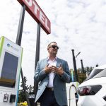 Electric Era Chief Revenue Officer Kyler Schmitz speaks during the grand opening of the states first electric vehicle fast-charging station on Tuesday, June 24, 2025 in Arlington, Washington. (Olivia Vanni / The Herald)