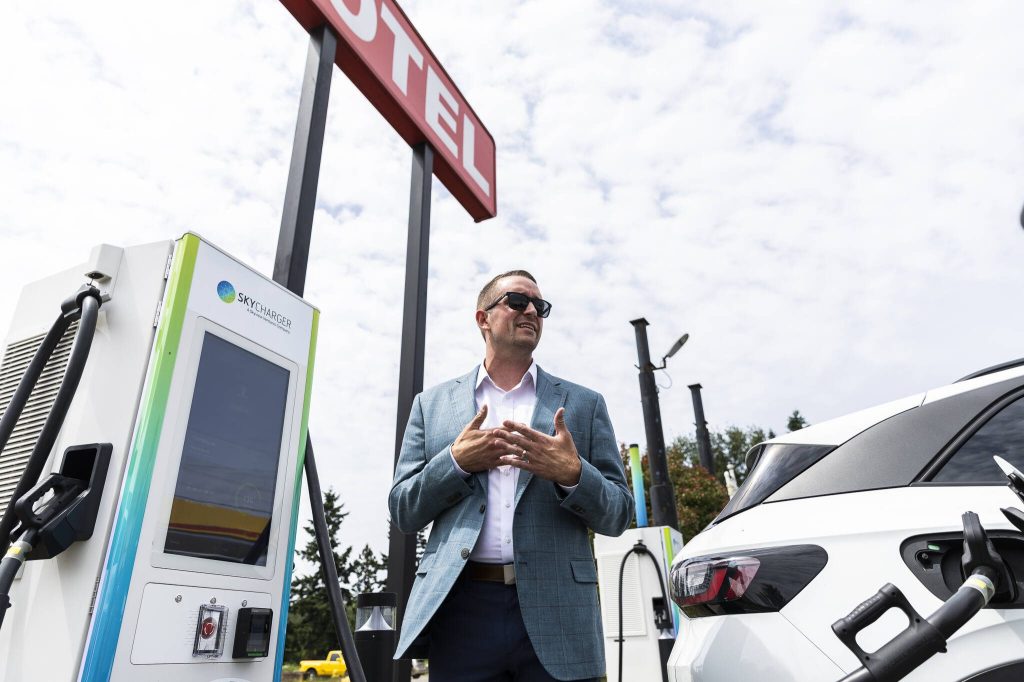 Electric Era Chief Revenue Officer Kyler Schmitz speaks during the grand opening of the states first electric vehicle fast-charging station on Tuesday, June 24, 2025 in Arlington, Washington. (Olivia Vanni / The Herald)