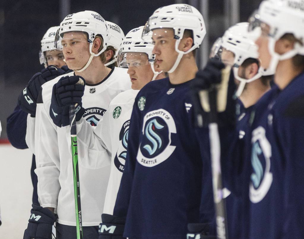 Julius Miettinen and other players listen to instructions during Kraken Development Camp on-ice session for forwards on Tuesday, July 1, 2025 in Seattle, Washington. (Olivia Vanni / The Herald)