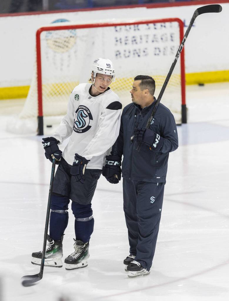 Julius Miettinen talks with a coach during Kraken Development Camp on-ice session for forwards on Tuesday, July 1, 2025 in Seattle, Washington. (Olivia Vanni / The Herald)
