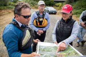 U.S. Rep. Suzan DelBene, right, goes over a Chinook Marsh Project map with Snohomish County Surface Water Management’s Michael Rustay, left, and Erik Stockdale, center, at the project site on Tuesday, Aug. 13, 2024 in Snohomish, Washington. (Olivia Vanni / The Herald)